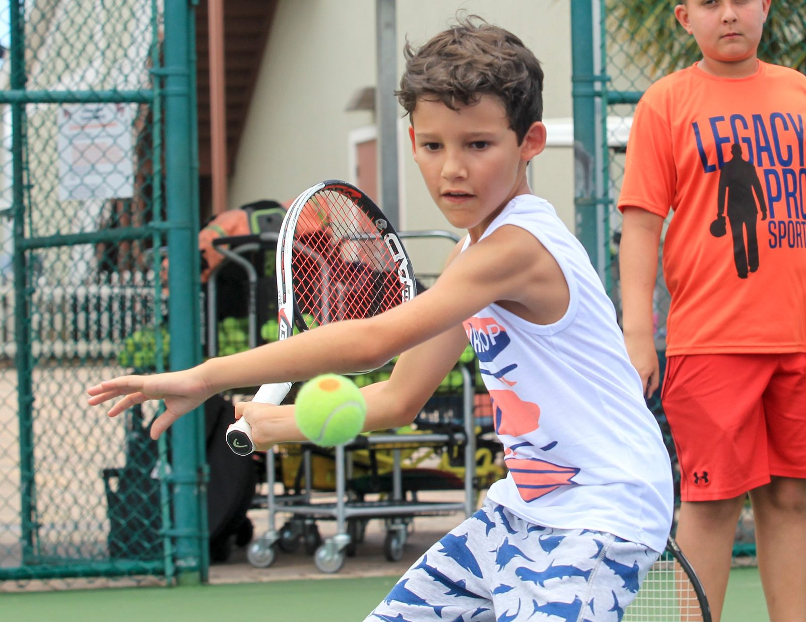 Young player focused on the ball at an Orlando Tennis Academy camp